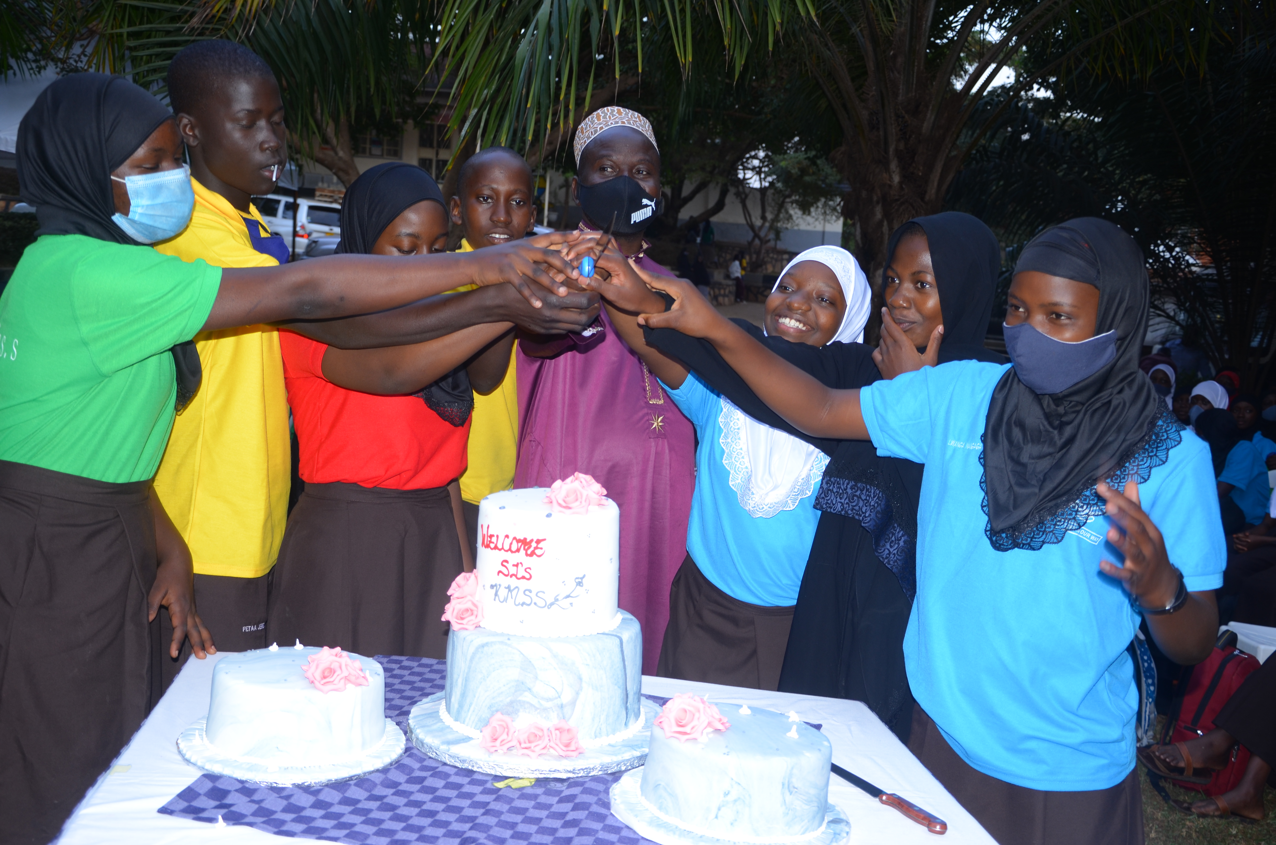 <p>Cutting the cake with the Deputy Head teacher Hajj Mayanaja Moses<br></p>